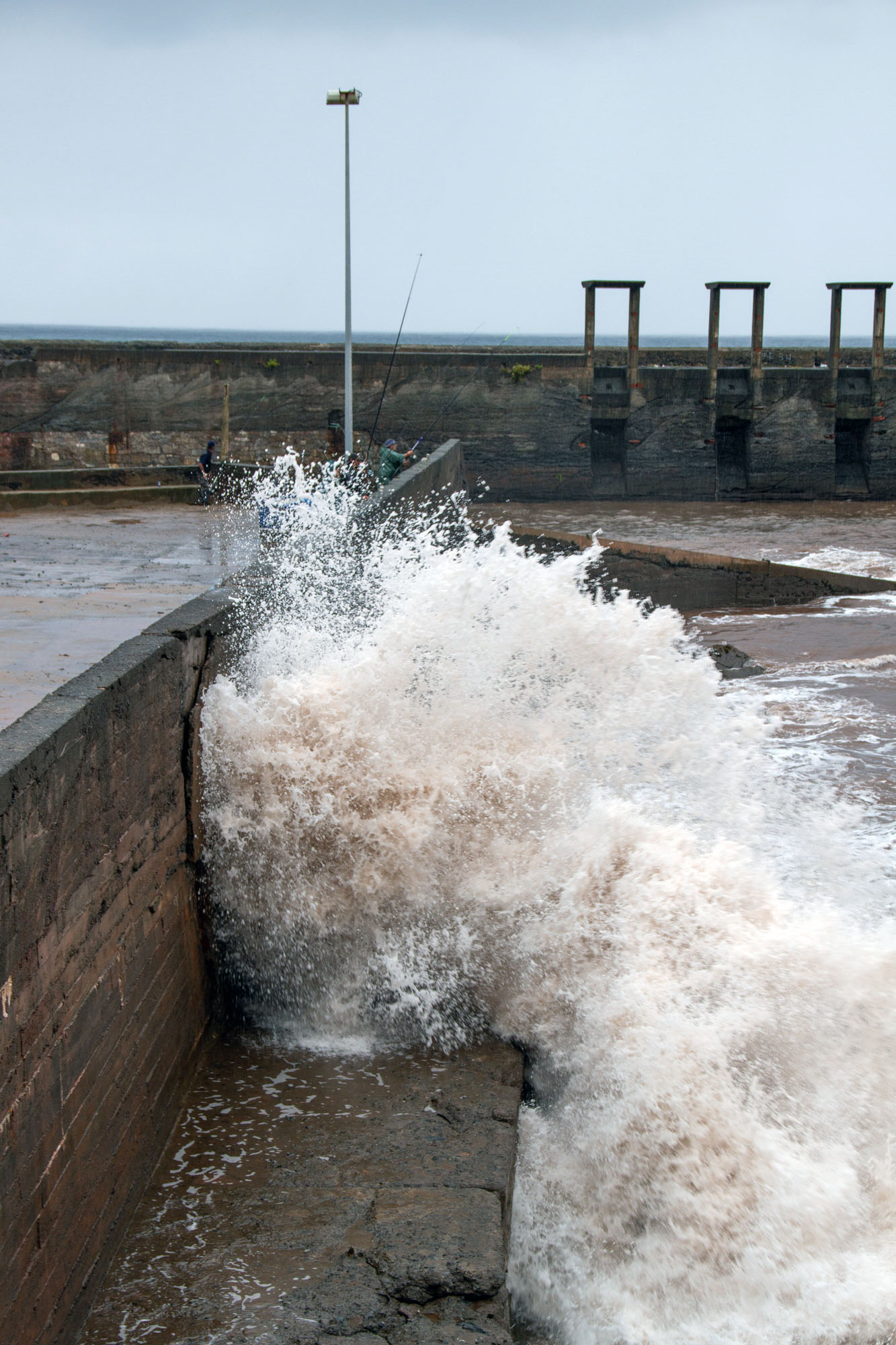 Wave splashing against harbor Asturias